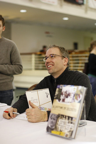 Frank signing one of the books. Taking credit for the work of others.